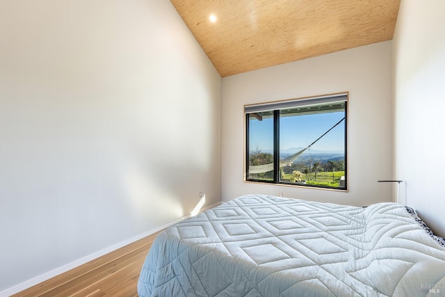 bedroom featuring lofted ceiling and light hardwood / wood-style floors