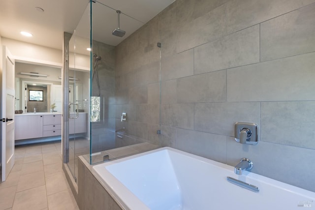 bathroom featuring tile walls, vanity, tile patterned flooring, and separate shower and tub