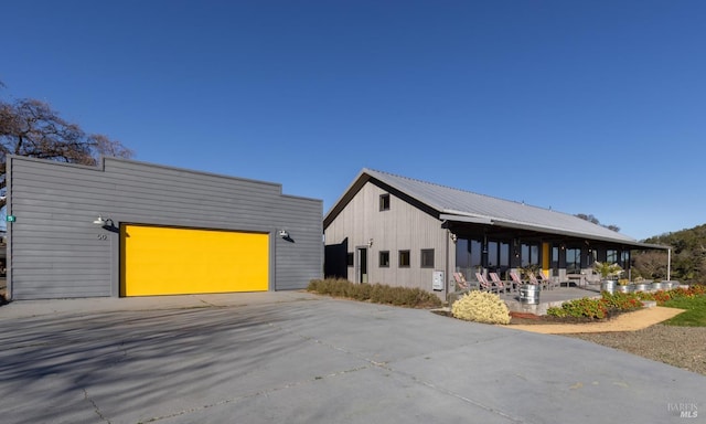 view of property exterior with a garage and an outbuilding