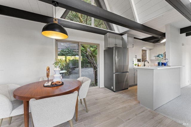 dining space with beam ceiling