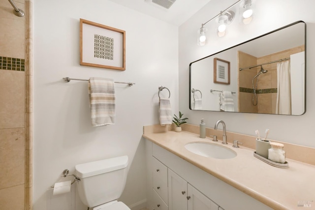 bathroom featuring toilet, vanity, and a shower with curtain