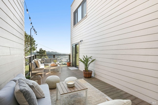 wooden terrace featuring outdoor lounge area