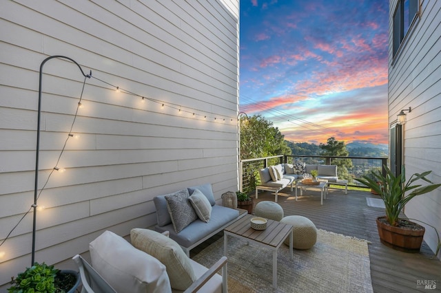 deck at dusk with an outdoor hangout area