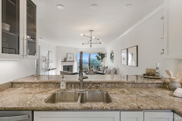 kitchen with dishwasher, light stone countertops, and white cabinets