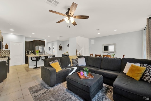 living area with visible vents, stairway, light tile patterned floors, recessed lighting, and a ceiling fan