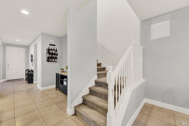 stairway with tile patterned floors, baseboards, and recessed lighting