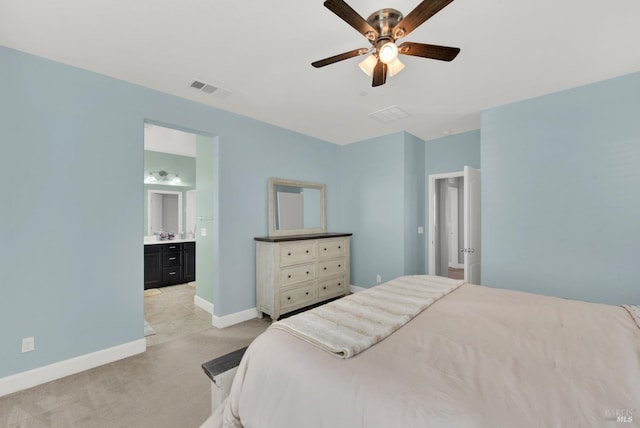 bedroom featuring visible vents, ensuite bath, baseboards, light colored carpet, and ceiling fan