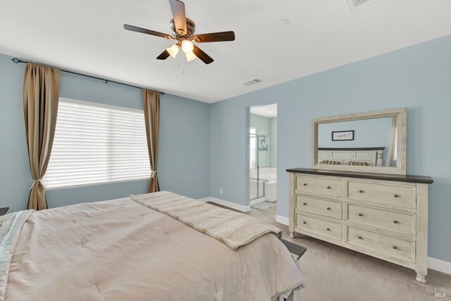 bedroom featuring a ceiling fan, baseboards, visible vents, carpet floors, and ensuite bath