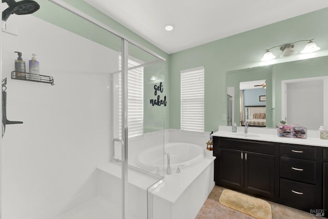 full bathroom with a ceiling fan, ensuite bath, a shower stall, a bath, and vanity