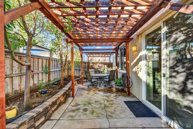 view of patio with outdoor dining area, a fenced backyard, and a pergola