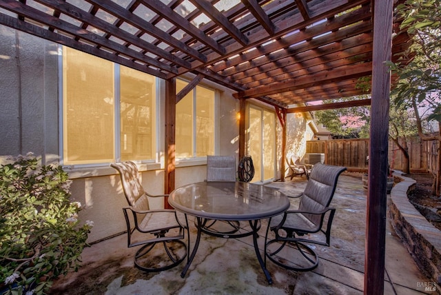 view of patio featuring outdoor dining area, fence, and a pergola