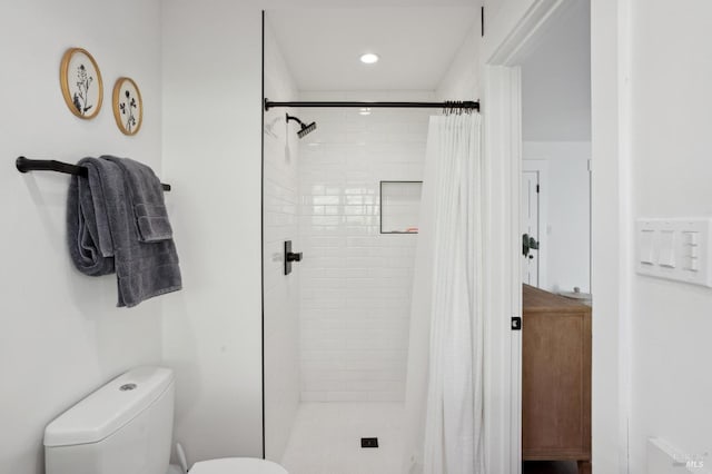 bathroom with walk in shower and toilet