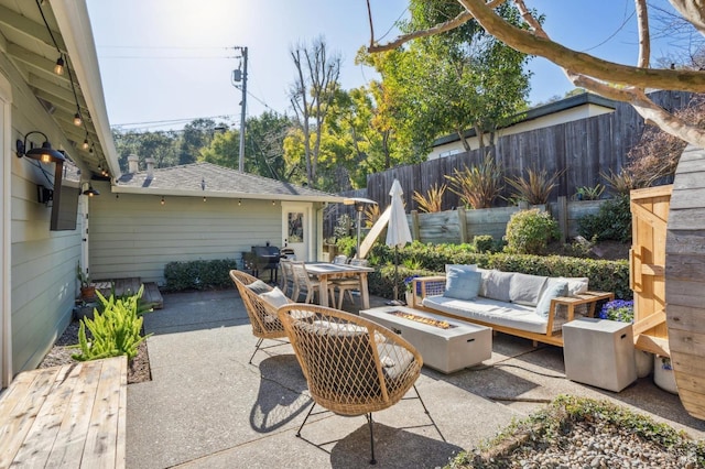 view of patio featuring an outdoor living space with a fire pit