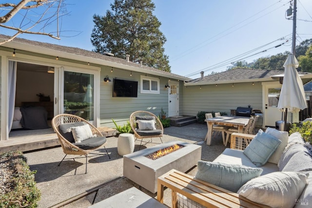 view of patio / terrace featuring an outdoor living space with a fire pit and grilling area