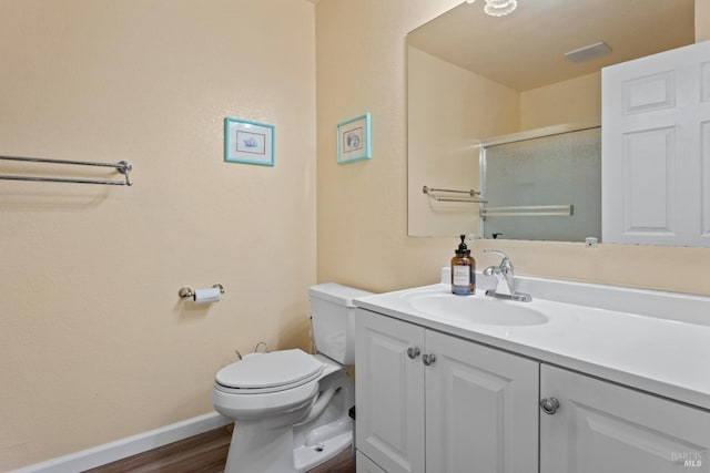 bathroom featuring an enclosed shower, vanity, hardwood / wood-style flooring, and toilet