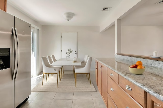 interior space featuring light tile patterned floors and visible vents