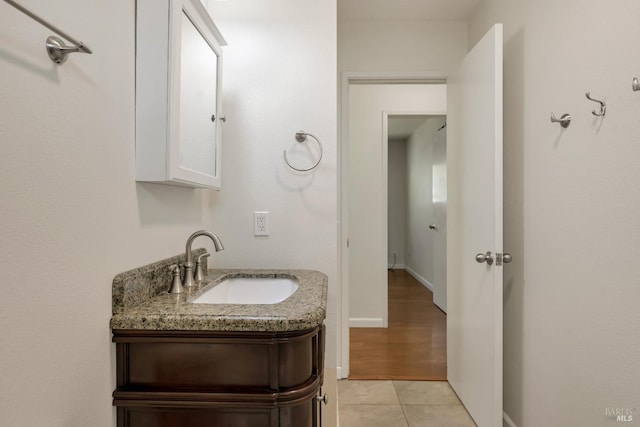 bathroom featuring vanity, baseboards, and tile patterned floors