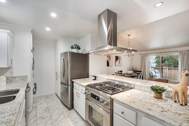 kitchen featuring appliances with stainless steel finishes, island range hood, white cabinetry, sink, and light stone countertops