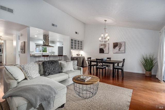 living room with wood-type flooring and a notable chandelier