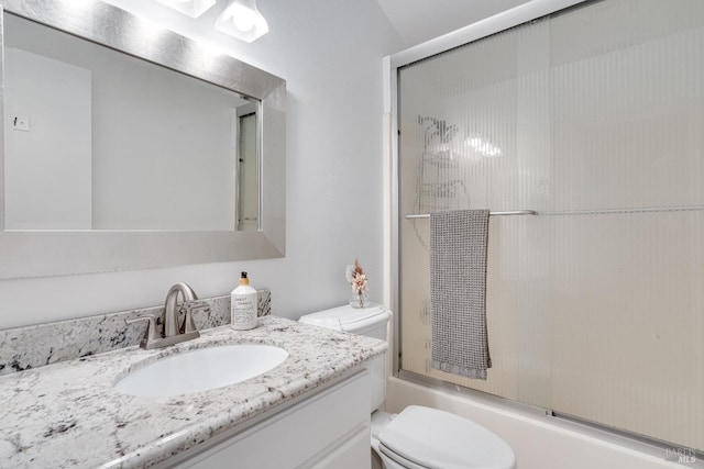 full bathroom featuring vanity, toilet, and combined bath / shower with glass door