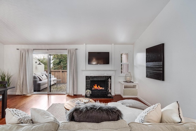 living room with hardwood / wood-style flooring and vaulted ceiling