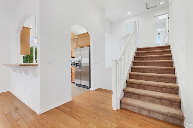 stairs with hardwood / wood-style flooring