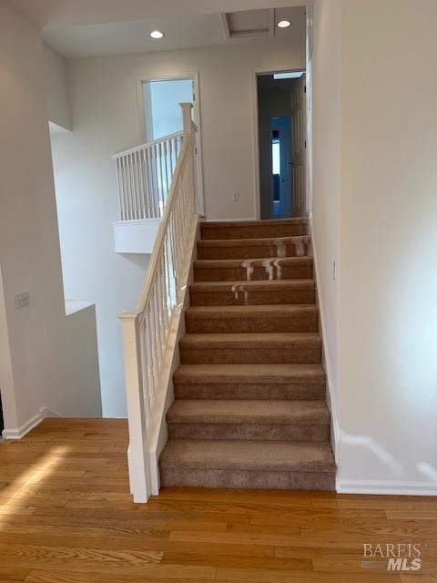 stairs with hardwood / wood-style floors