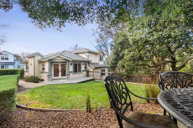 back of house featuring a yard and french doors