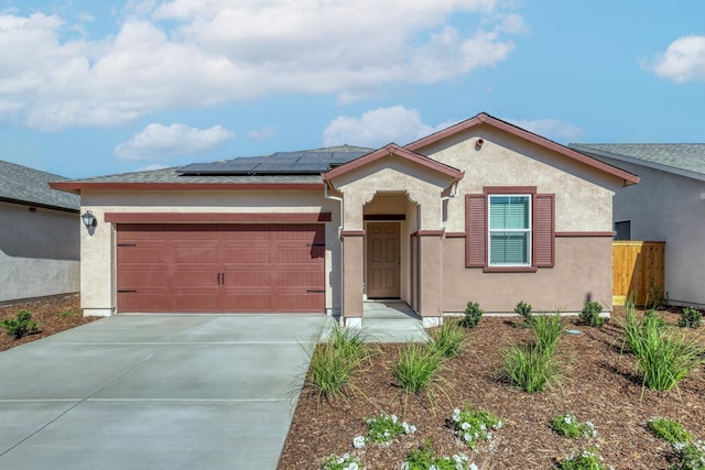 view of front of home with a garage and solar panels