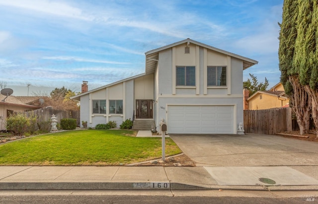 view of front of house with a garage and a front lawn