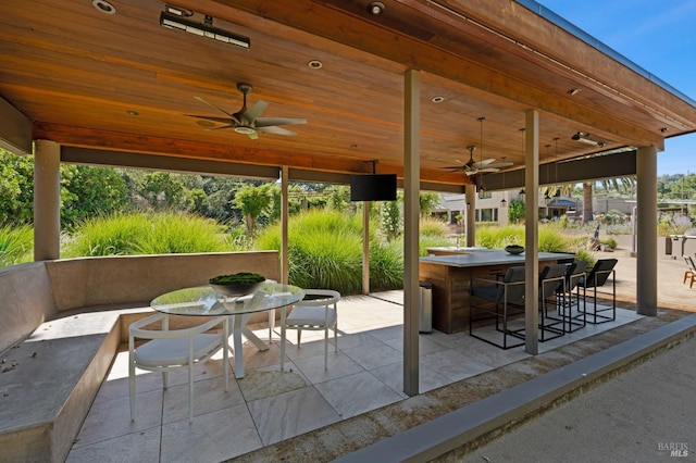 view of patio with an outdoor bar and ceiling fan