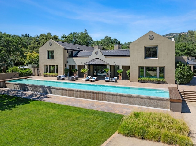 view of swimming pool with a yard and a patio area