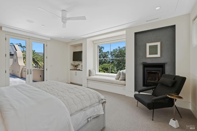 carpeted bedroom with access to exterior, ceiling fan, and french doors