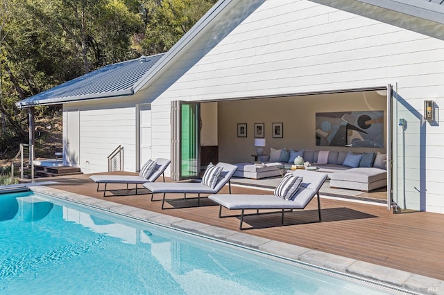 rear view of house featuring a swimming pool side deck and an outdoor hangout area