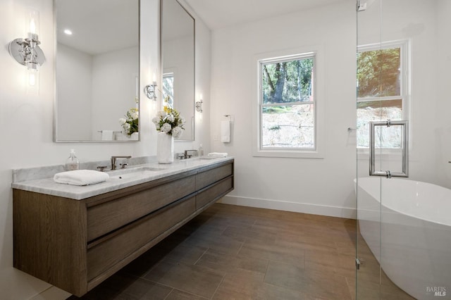 bathroom with vanity and a bathtub