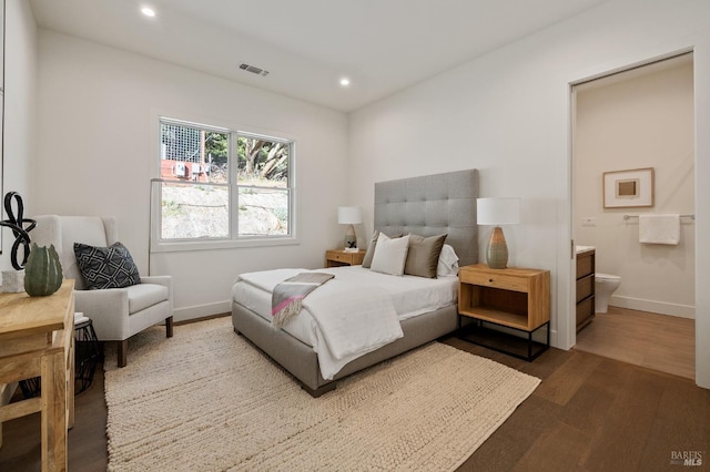 bedroom featuring wood-type flooring and connected bathroom