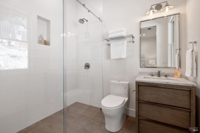 bathroom with vanity, toilet, and walk in shower