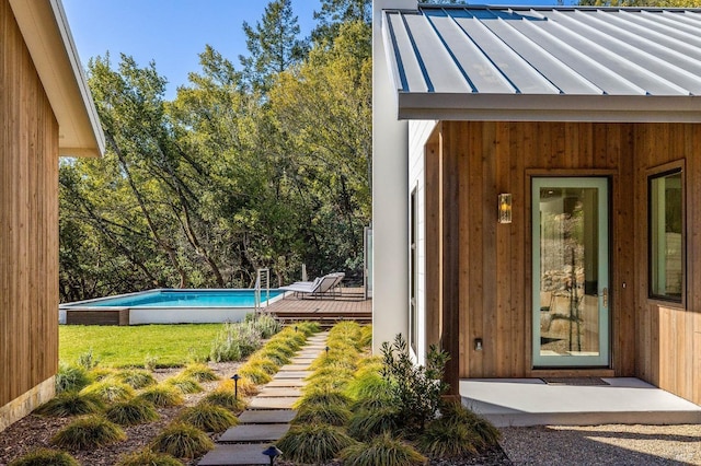 doorway to property featuring a lawn