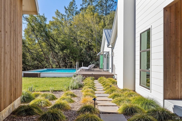 view of yard with a swimming pool side deck