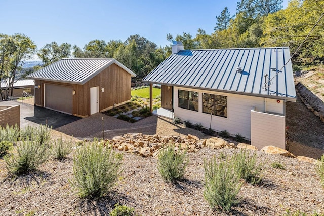 view of side of property featuring an outbuilding and a garage