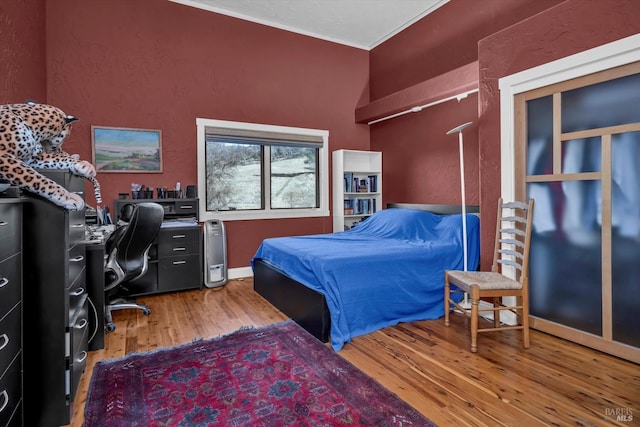 bedroom featuring crown molding and hardwood / wood-style floors