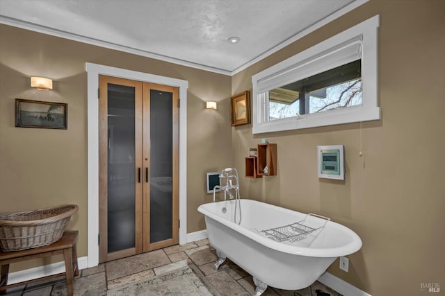 bathroom featuring crown molding, a bathtub, and french doors