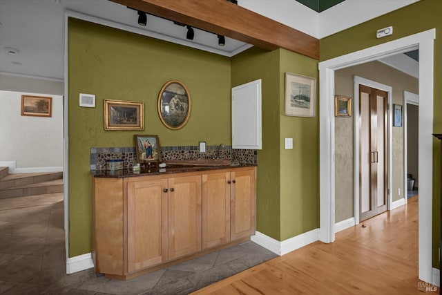 bar featuring decorative backsplash and light wood-type flooring