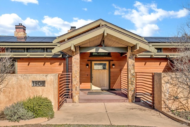 doorway to property featuring solar panels