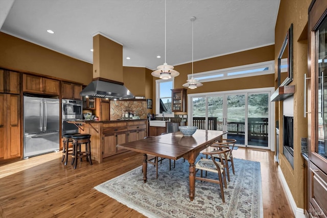 dining room with sink and light hardwood / wood-style flooring