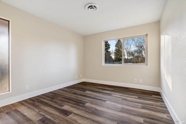 spare room with dark hardwood / wood-style floors