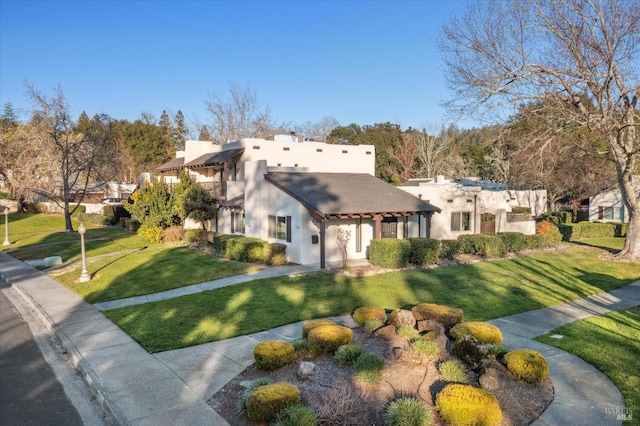 adobe home featuring a front yard