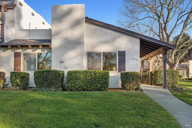 view of home's exterior with a yard