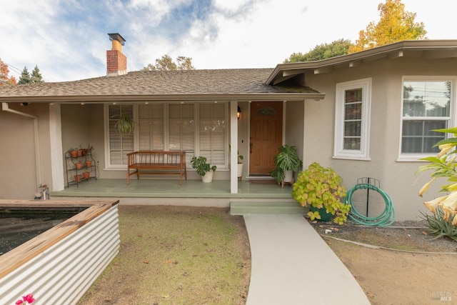 doorway to property featuring covered porch