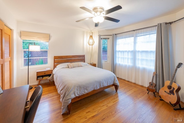 bedroom featuring light hardwood / wood-style flooring, a closet, and ceiling fan